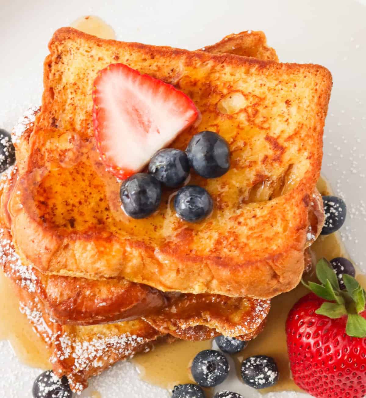 Brioche French Toast topped with strawberries and blueberries
