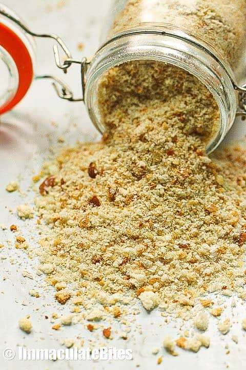 Fresh homemade breadcrumbs spilling from a jar