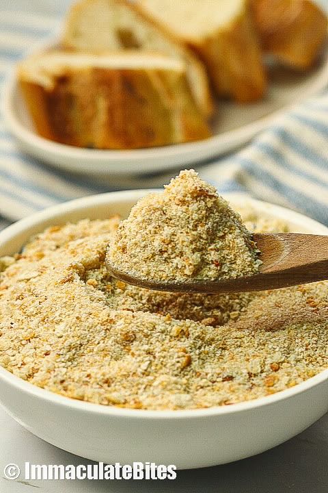 A bowl full of bread crumbs in a wooden spoon