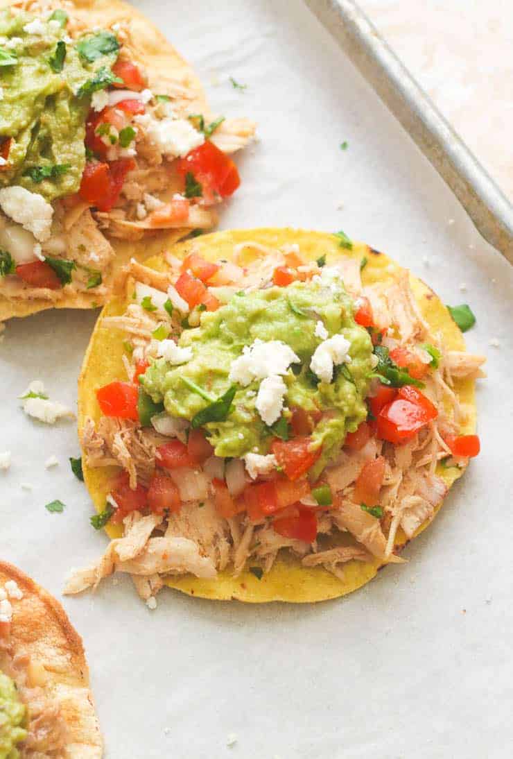 Chicken Tostadas with guac, tomatoes, and queso fresco.