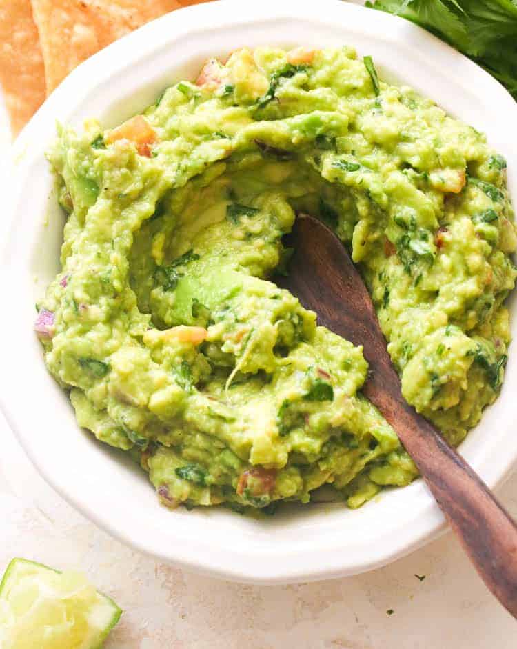 Classic guacamole with a wooden spoon