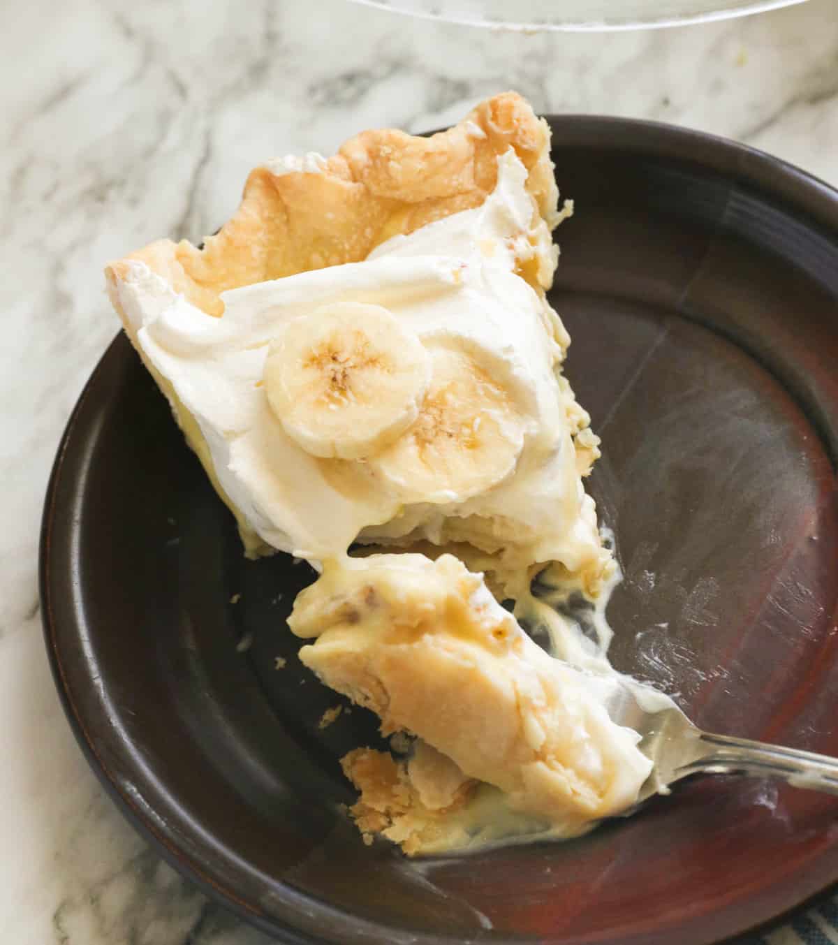 A slice of banana cream pie with a fork