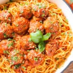 A top view of a bowl of spaghetti and meatballs