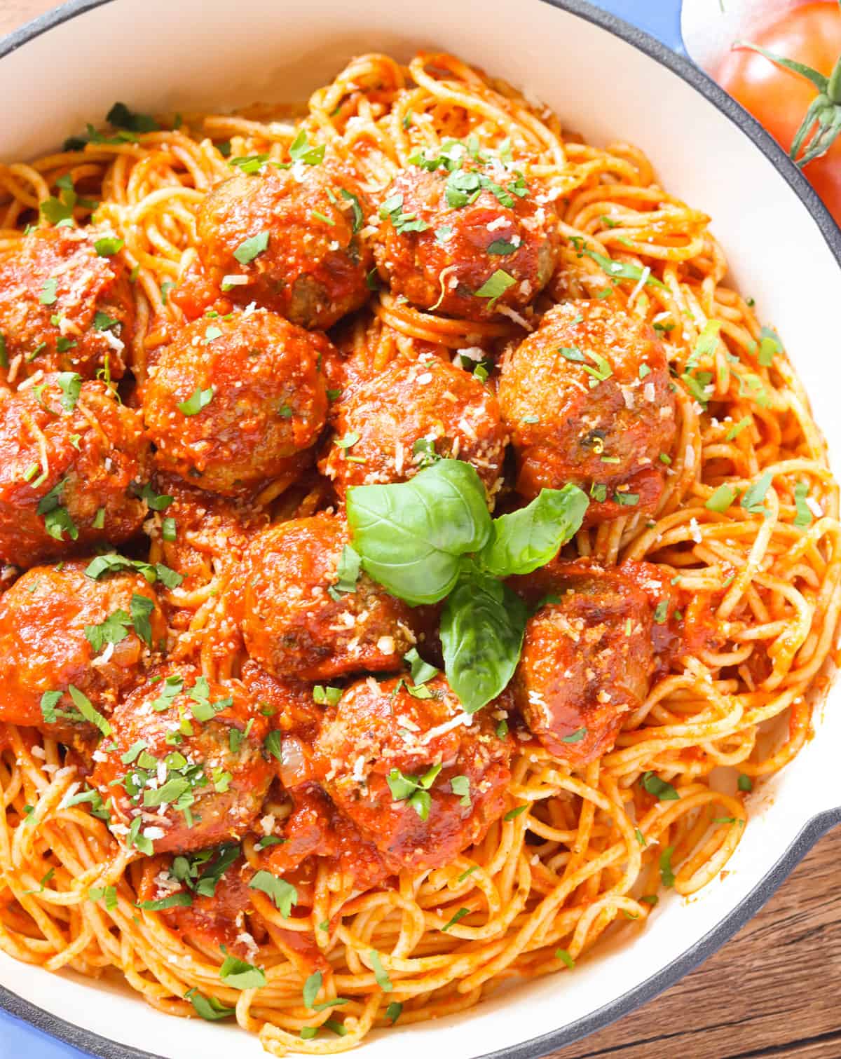 A top view of a bowl of spaghetti and meatballs