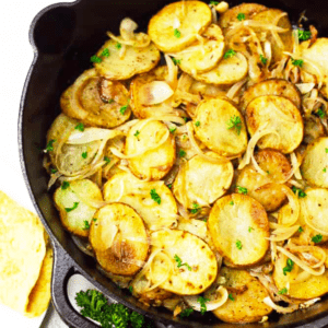 A skillet full of fried potatoes and onions