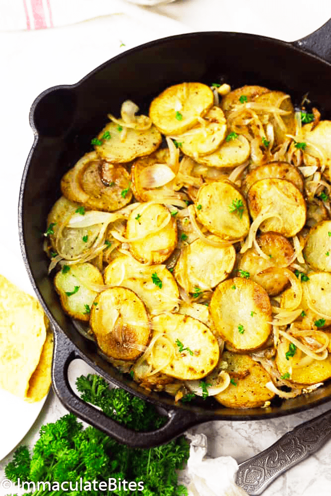 A skillet full of fried potatoes and onions