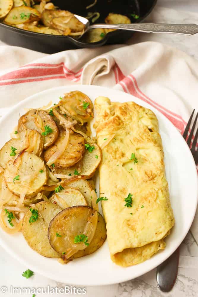 French fries and omelets with potatoes and onions on a plate