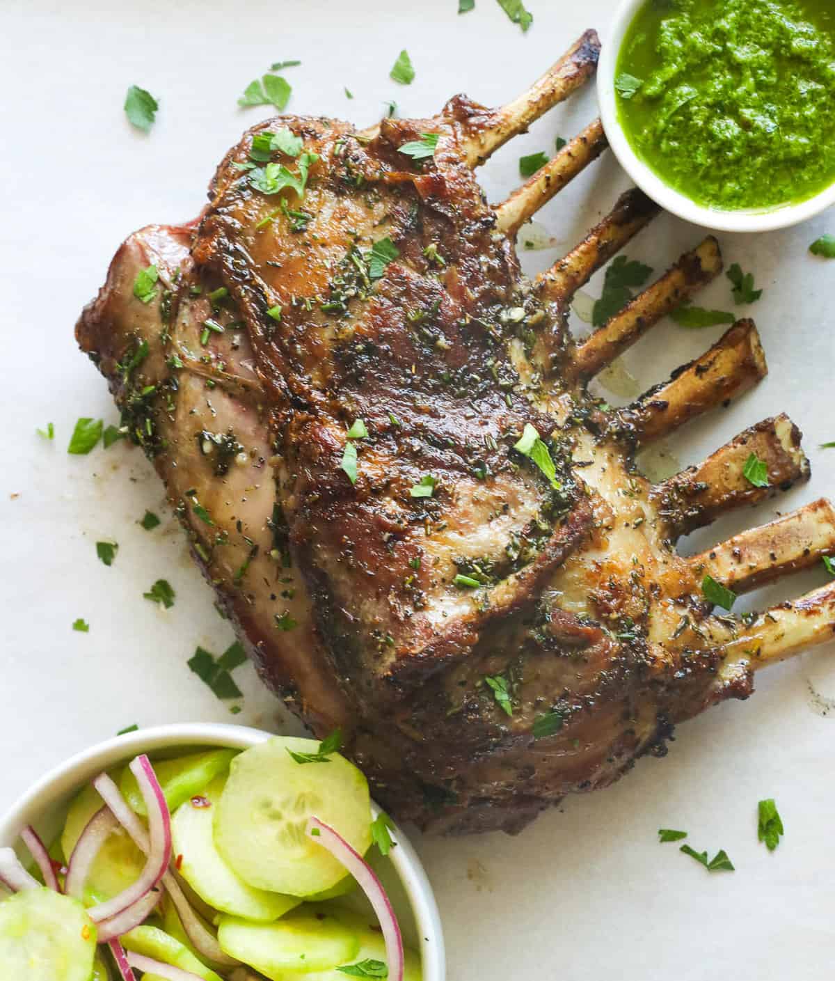 Grilled rack of lamb with green sauce and cucumber onion salad
