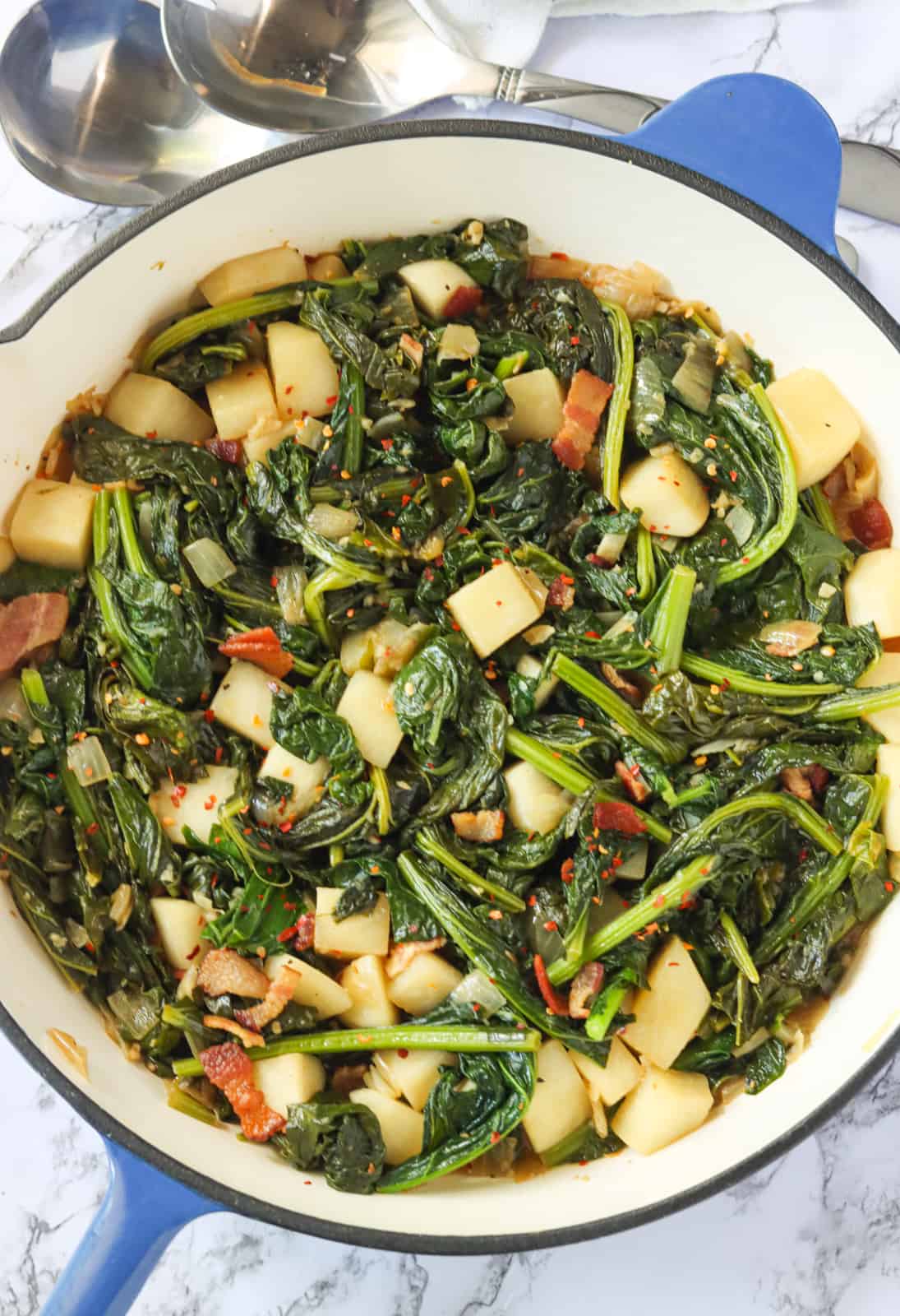 A pan full of turnips, their greens, and bacon.