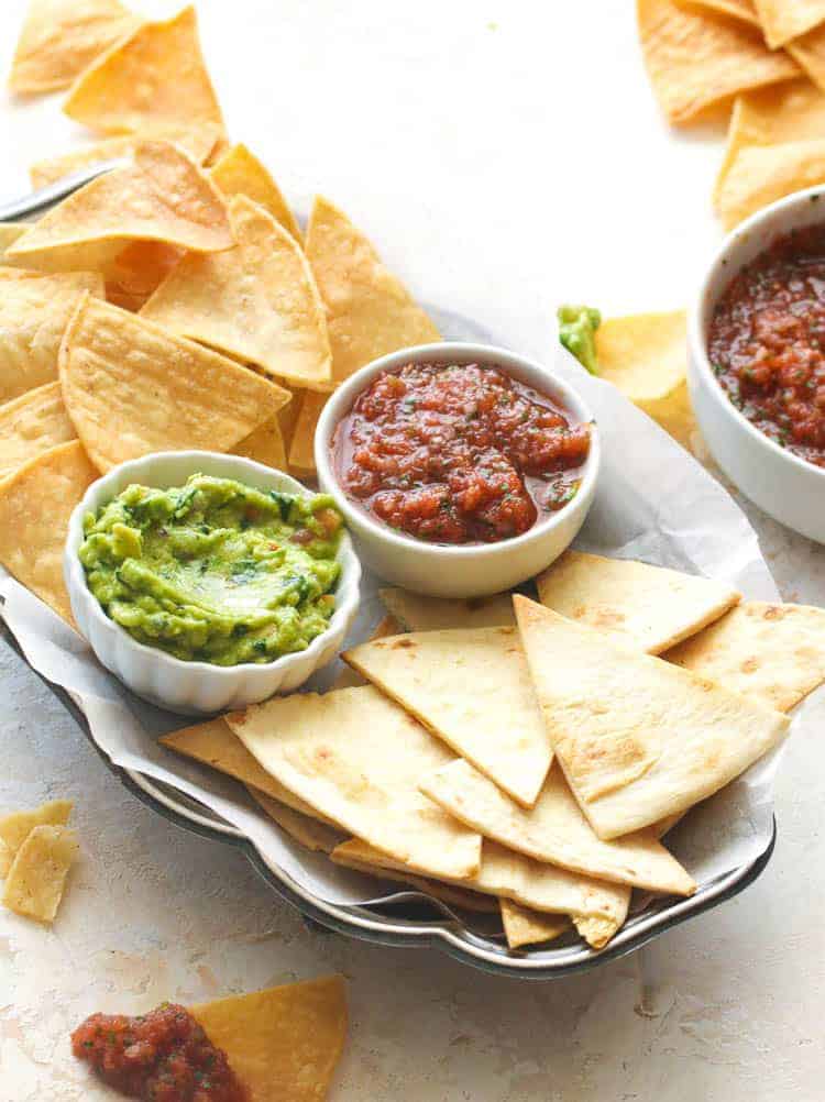 Homemade tortilla chips with guac and salsa