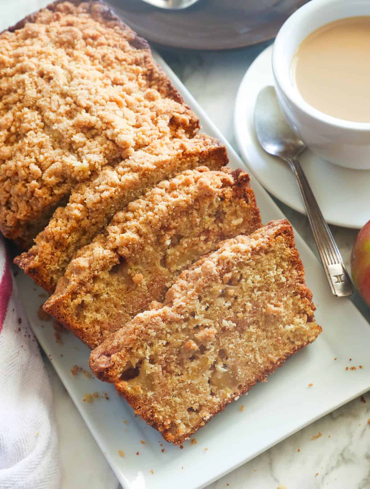 Freshly sliced apple bread with a cup of coffee to tempt your tastebuds