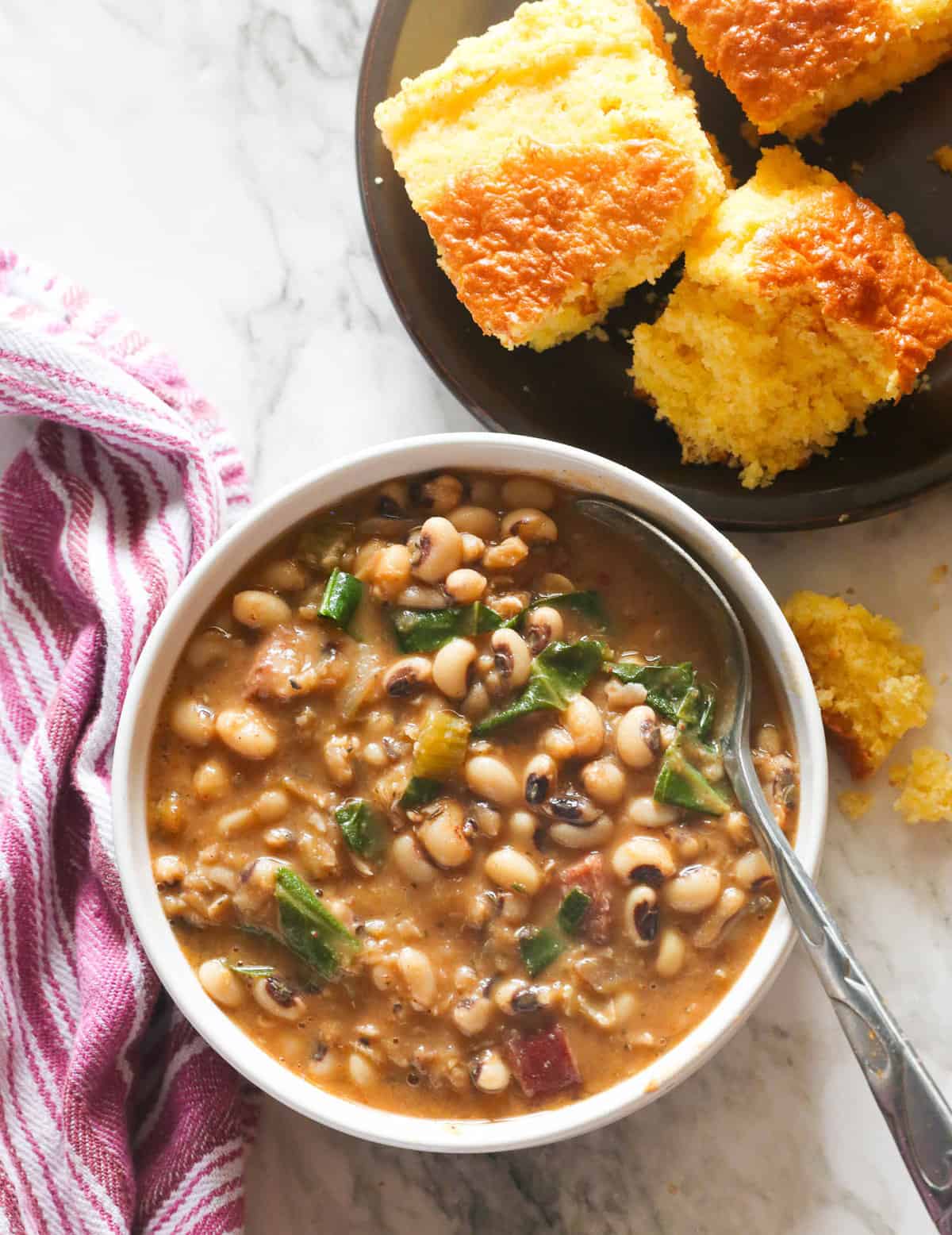 Crave-worthy bowl of Southern Black-Eyed Peas with a plate of cornbread