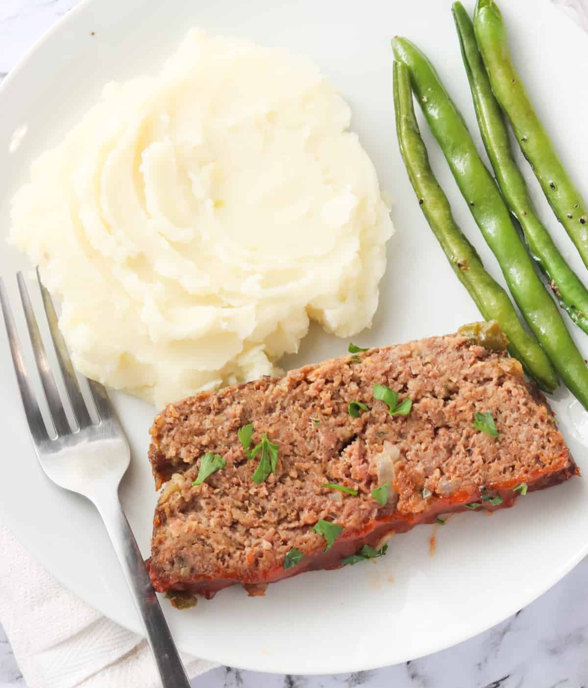 Enjoy southern meatloaf with mashed potatoes and roasted green beans