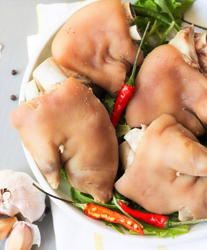 A plate of pickled pigs feet with chili peppers