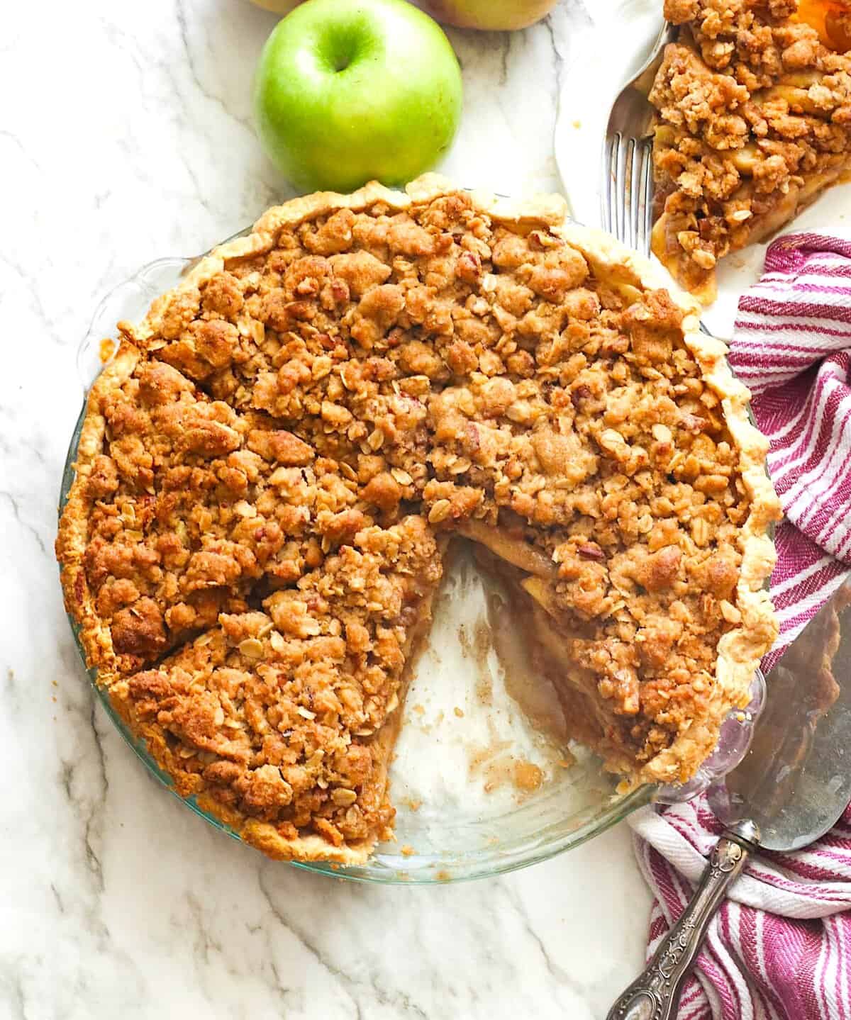 Freshly baked apple pie with a streusel topping, sliced and ready to serve.