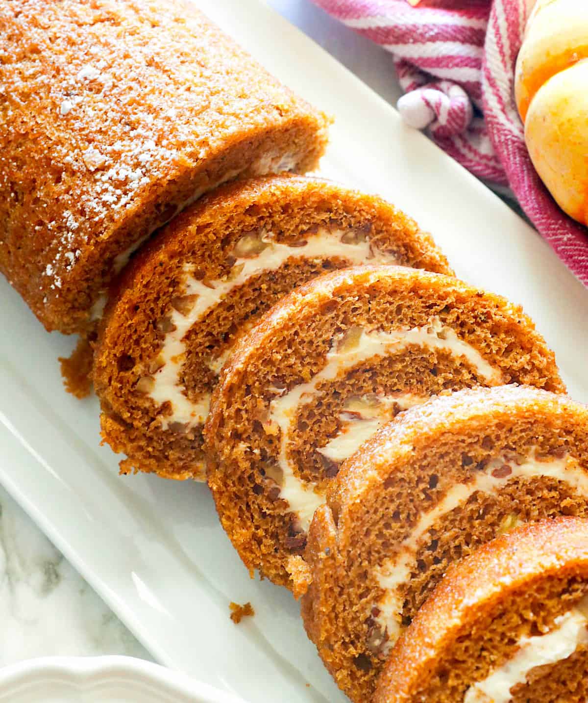 Slicing decadent pumpkin roll for the holidays