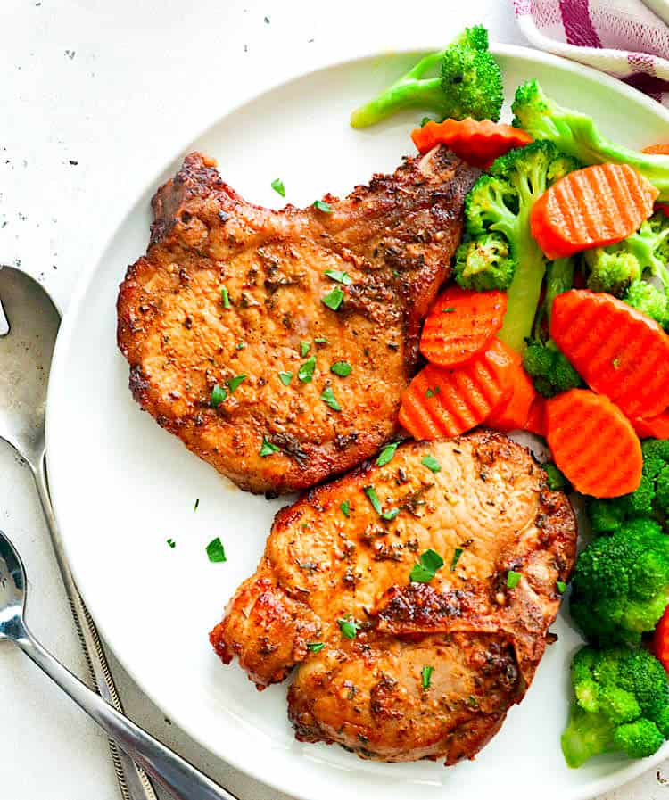 Air fryer pork chops and delicious roasted carrots and broccoli