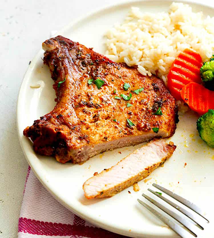 Insanely delicious air fryer pork chop with rice and vegetables