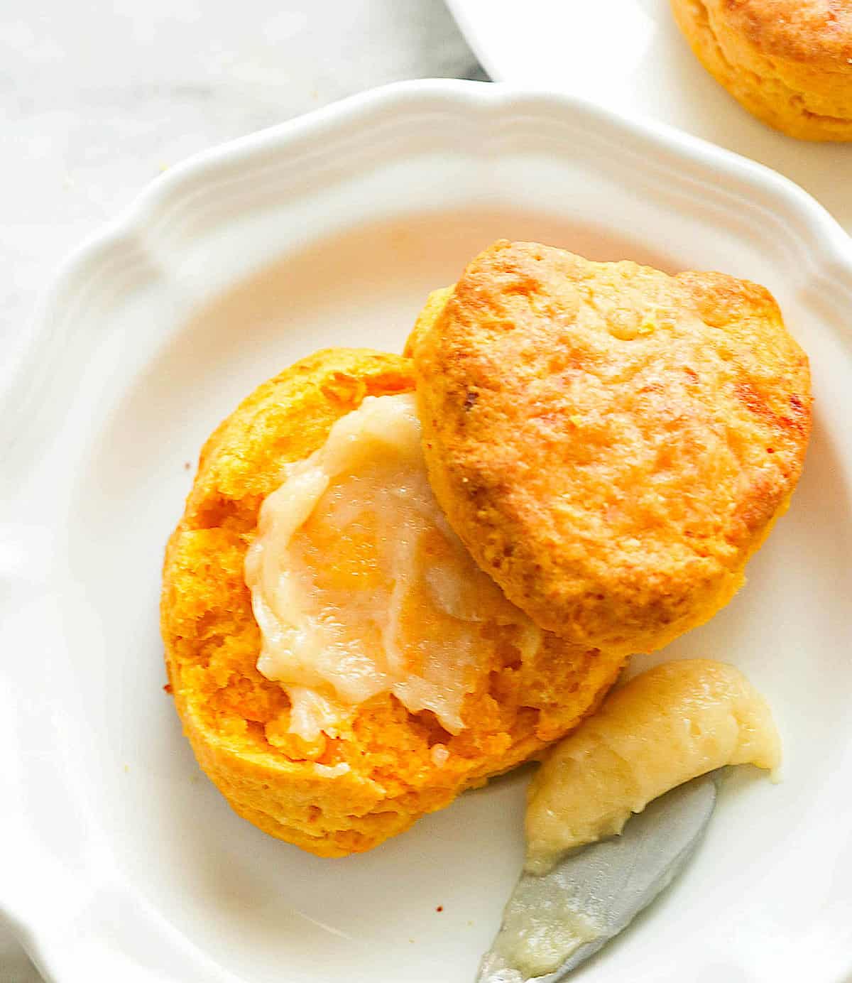 Melt-in-your-mouth sweet potato biscuits slathered with butter