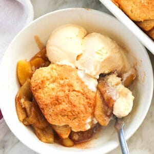 A bowl of insanely delicious apple cobbler with ice cream