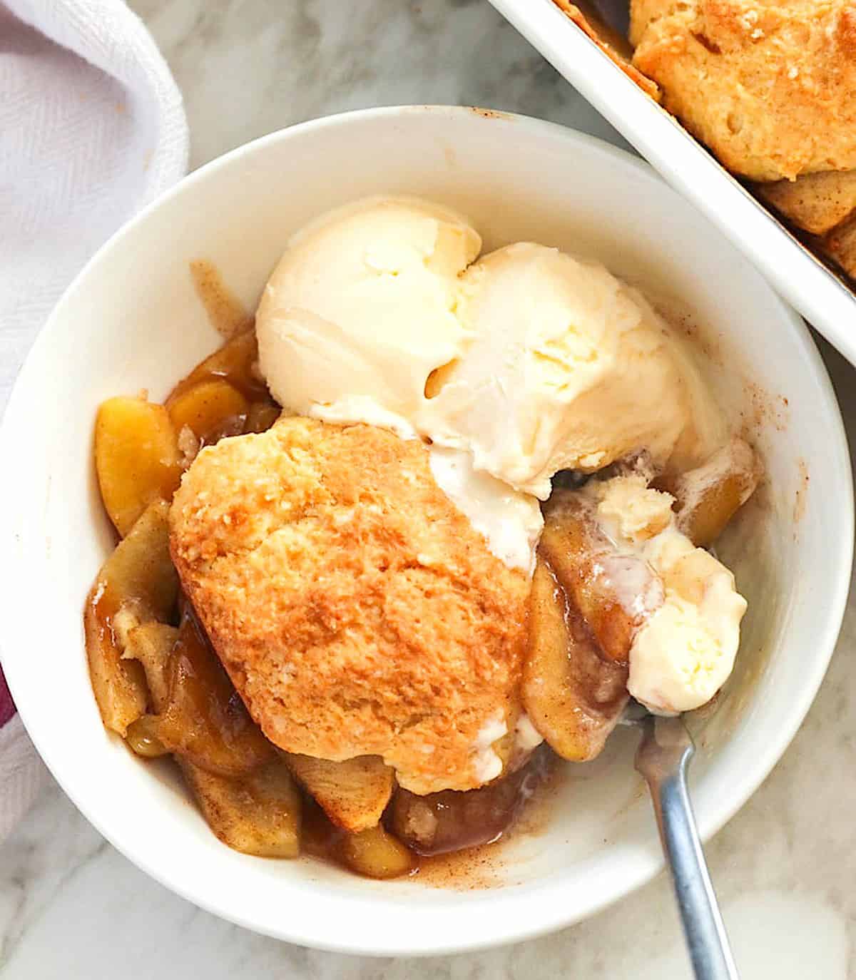 A bowl of insanely delicious apple cobbler with ice cream