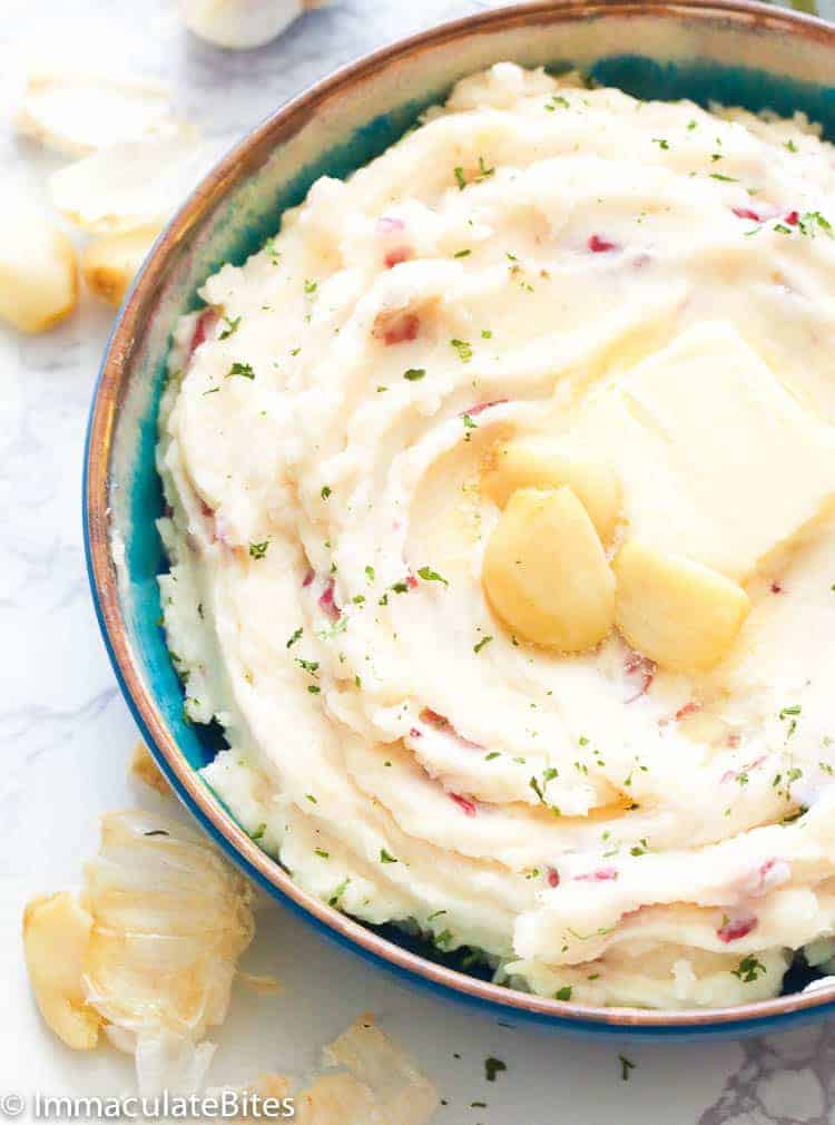 Perfectly creamy, buttery, and easy Garlic Mashed Red Potatoes with roasted garlic, thyme, sour cream, and milk.