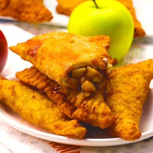Breaking into a freshly fried apple pie for a decadent snack.
