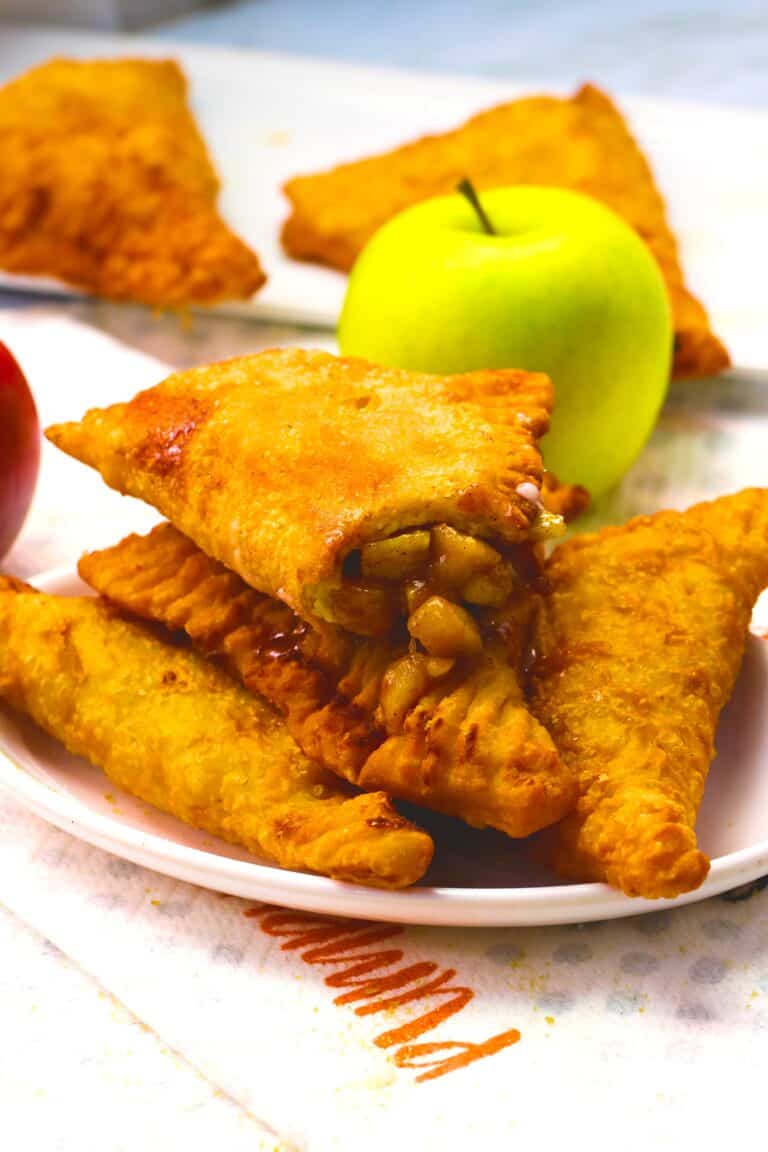 Breaking into a freshly fried apple pie for a decadent snack.