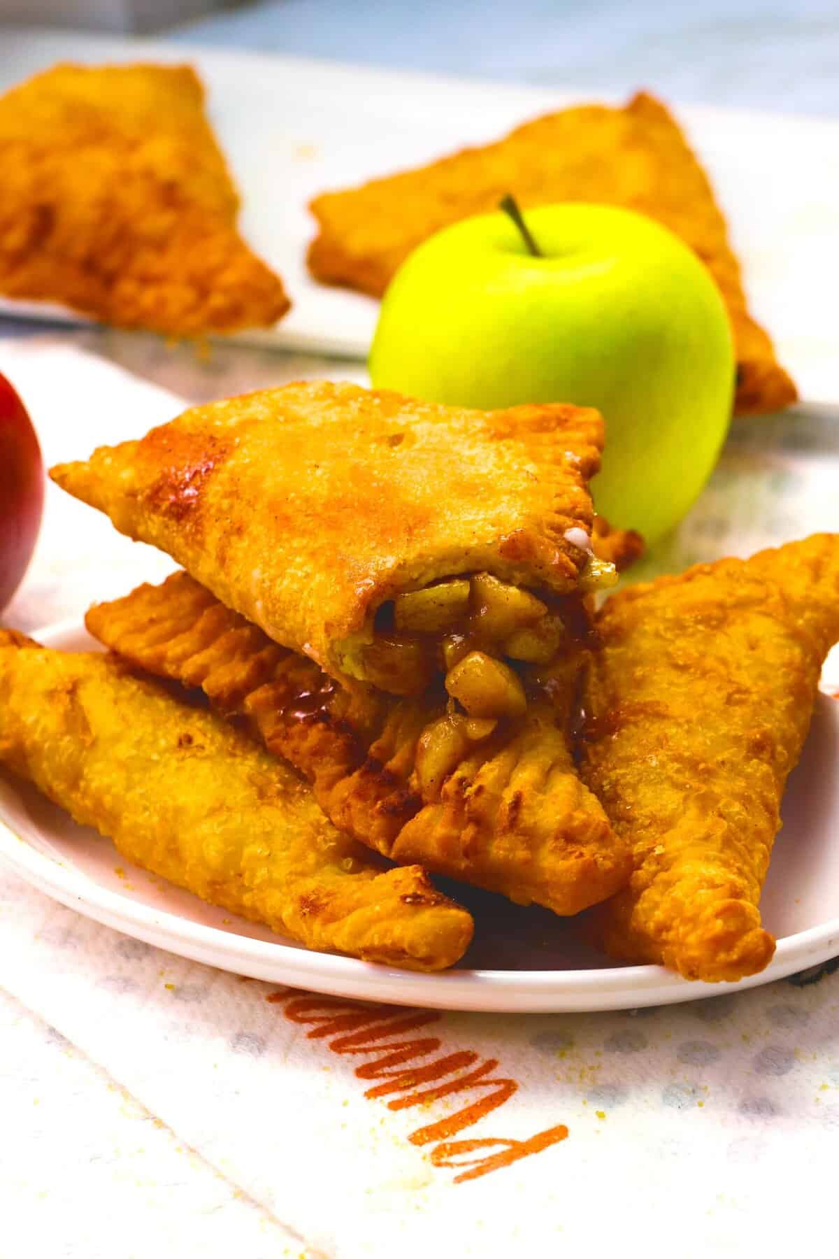 Breaking into a freshly fried apple pie for a decadent snack.