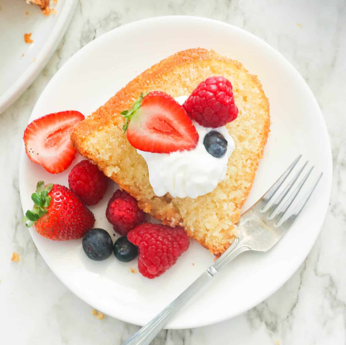 Enjoy Kentucky Butter Cake with berries and cream