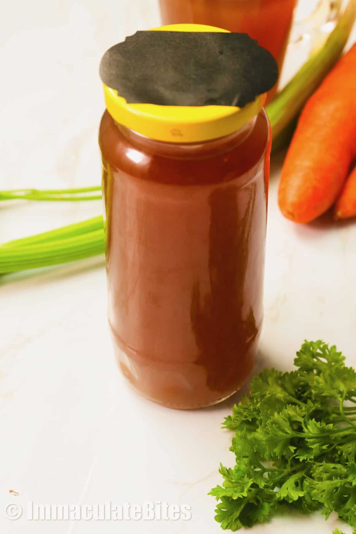 Finished beef broth in a jar and ready to store