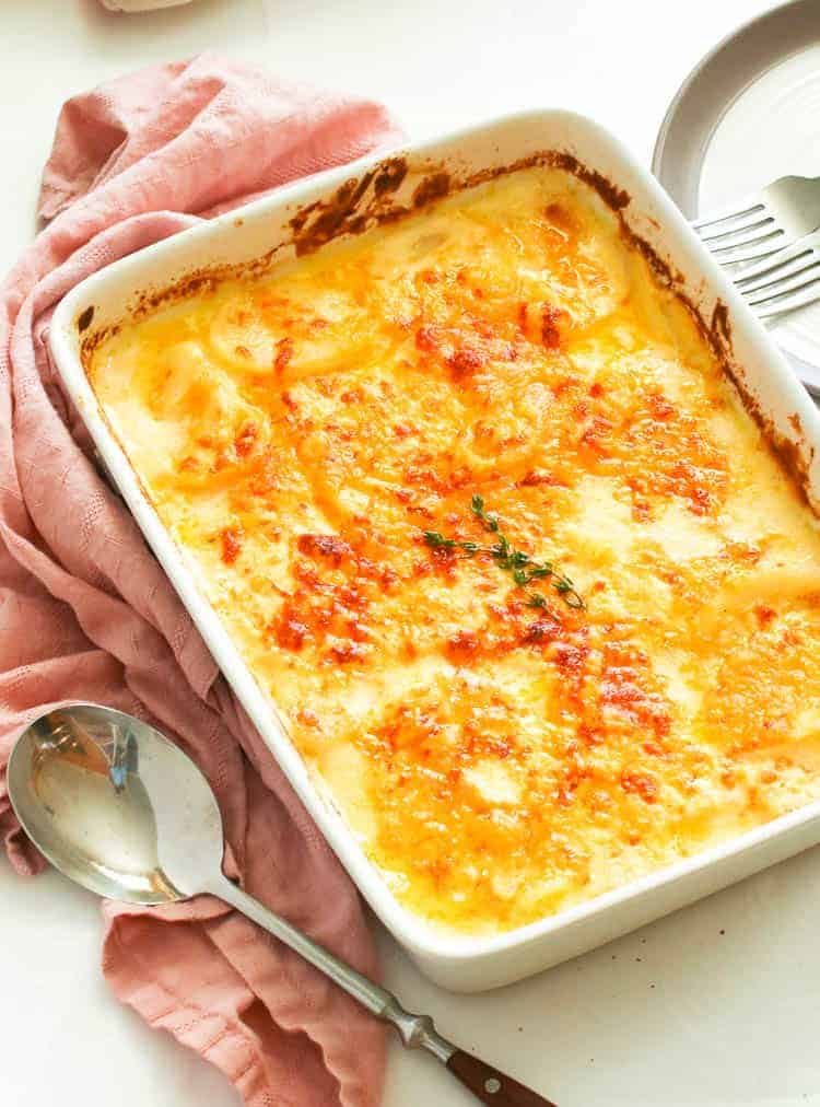 Potatoes au gratin sliced potatoes smothered in a decadent creamy, cheesy sauce 