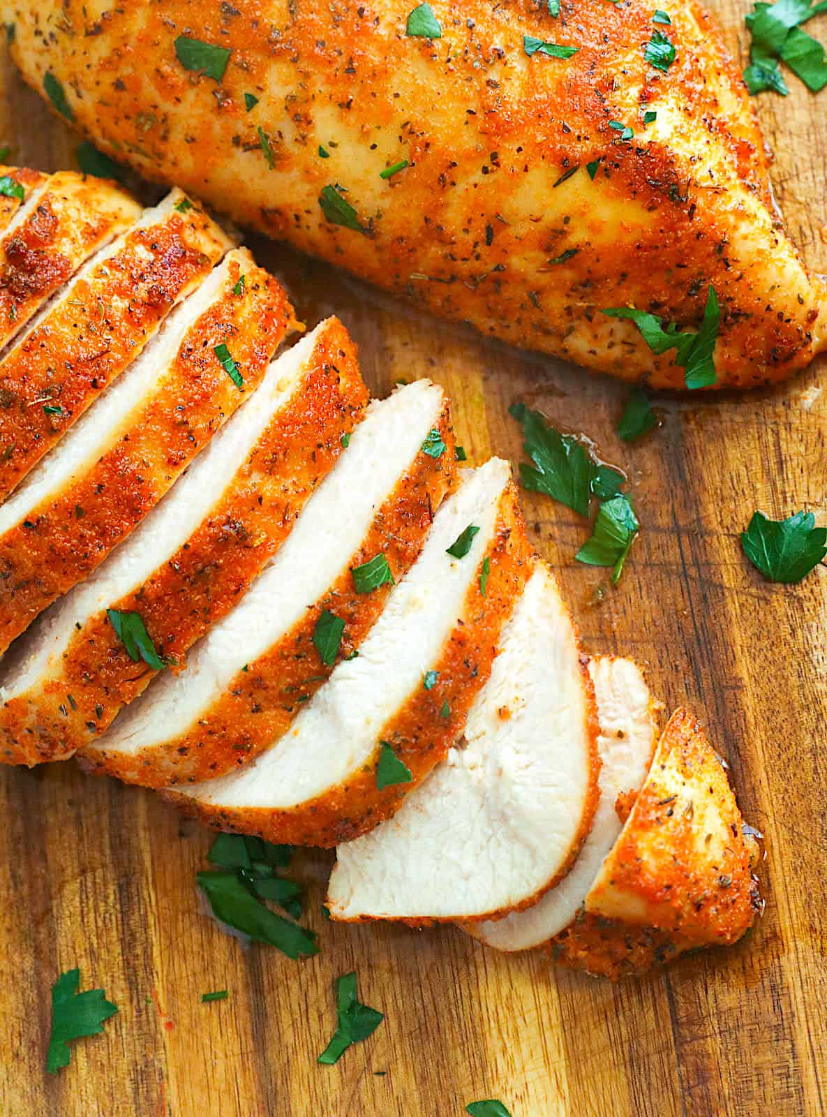 Slicing freshly baked chicken breasts