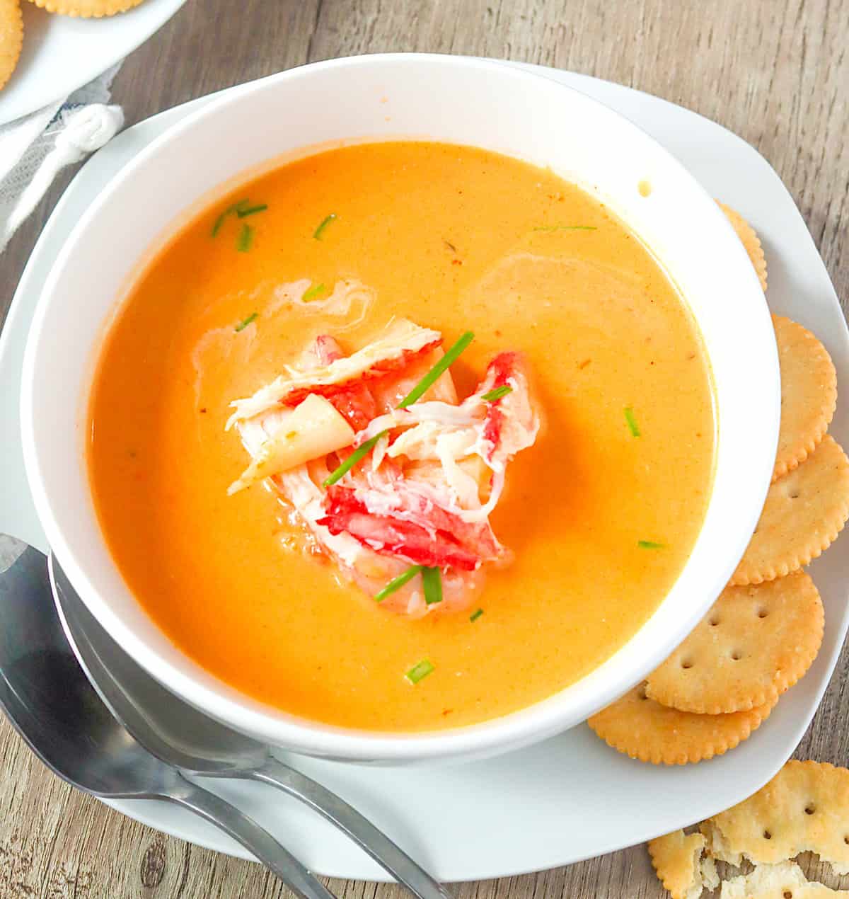 Enjoying a creamy bowl of crab bisque with crackers