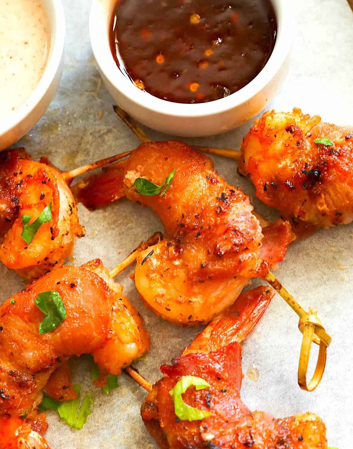 Serving hot sauce and remoulade with crispy, tender bacon-wrapped shrimp appetizers