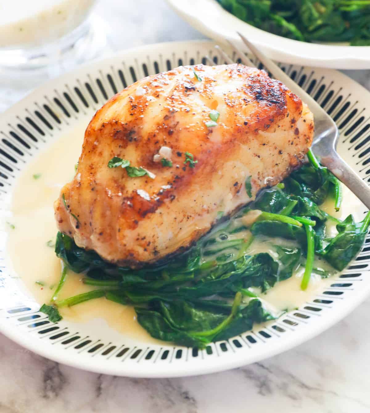 Delicious Chilean Sea Bass served on a bed of spinach and smothered in beurre blanc