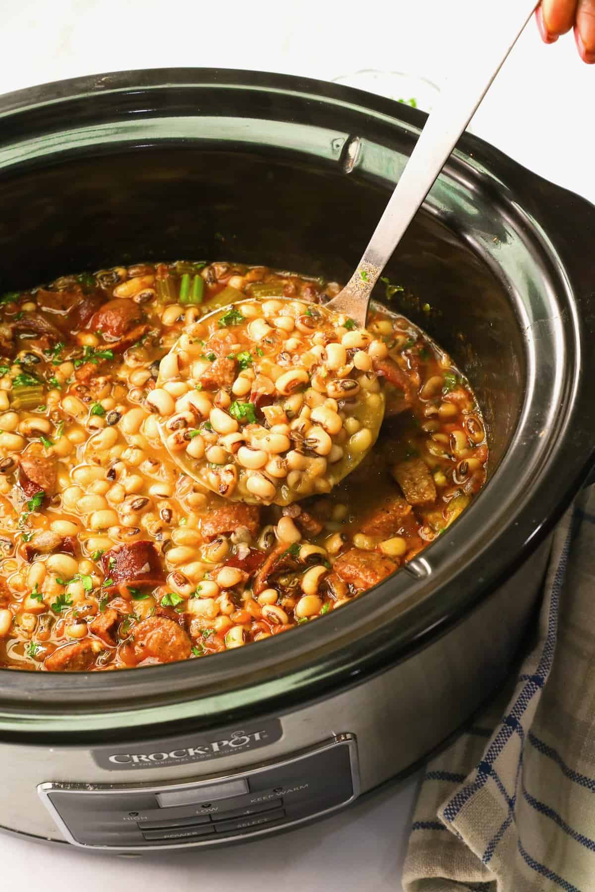 Serving up steaming slow cooker black eyed peas