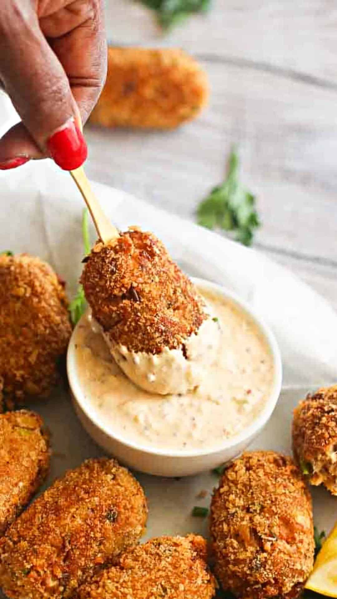 Salmon croquettes dipped in a creamy sauce.