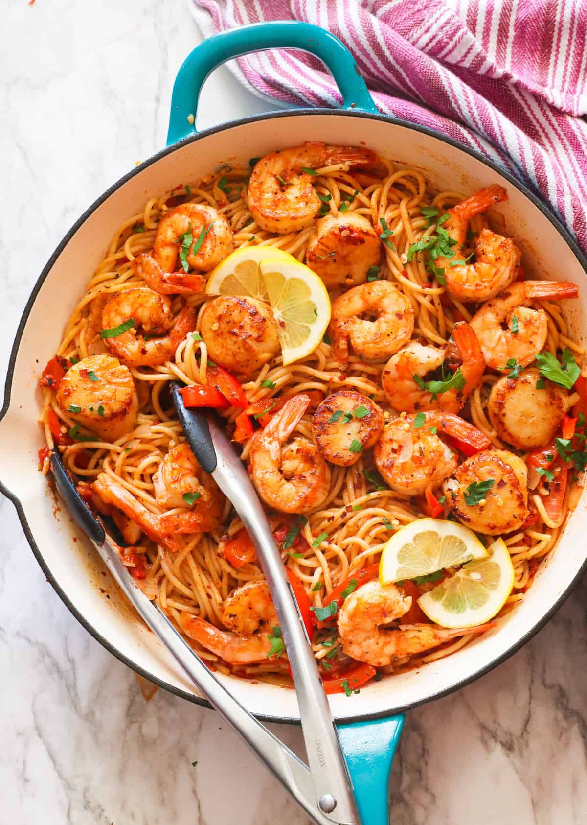 Mouthwatering seafood pasta with lemon wedges