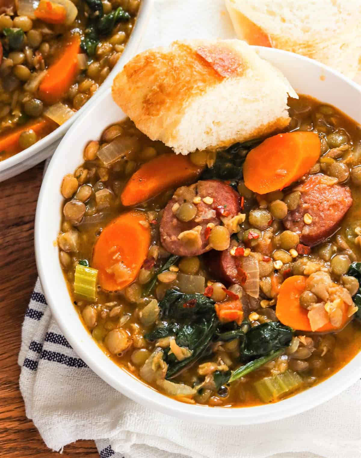 Soul-satisfying bowl of sausage lentil soup with fresh garlic bread