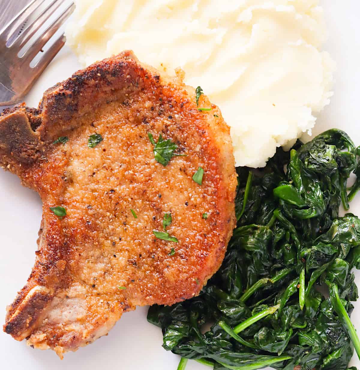 Fried pork chops with greens and mashed potatoes for incredible soul food