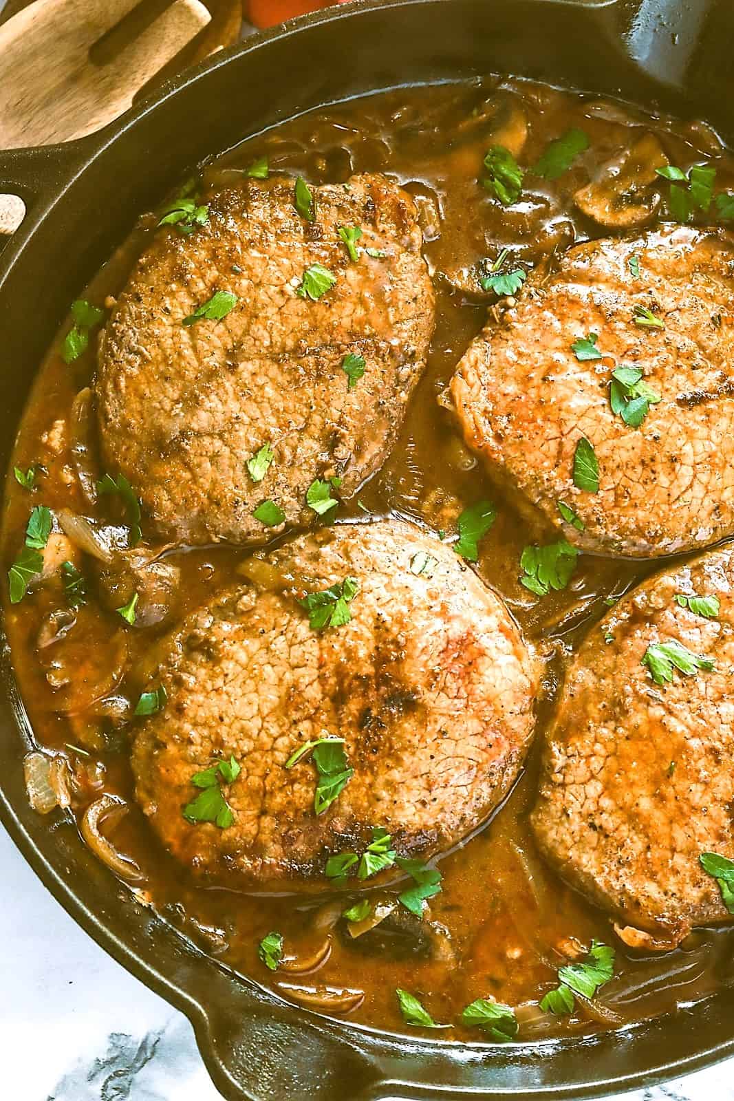 Smothered steak ready to come out of the pan