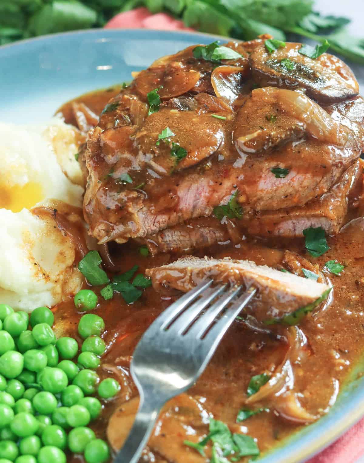 Enjoying digging into smothered steak for an easy weeknight meal