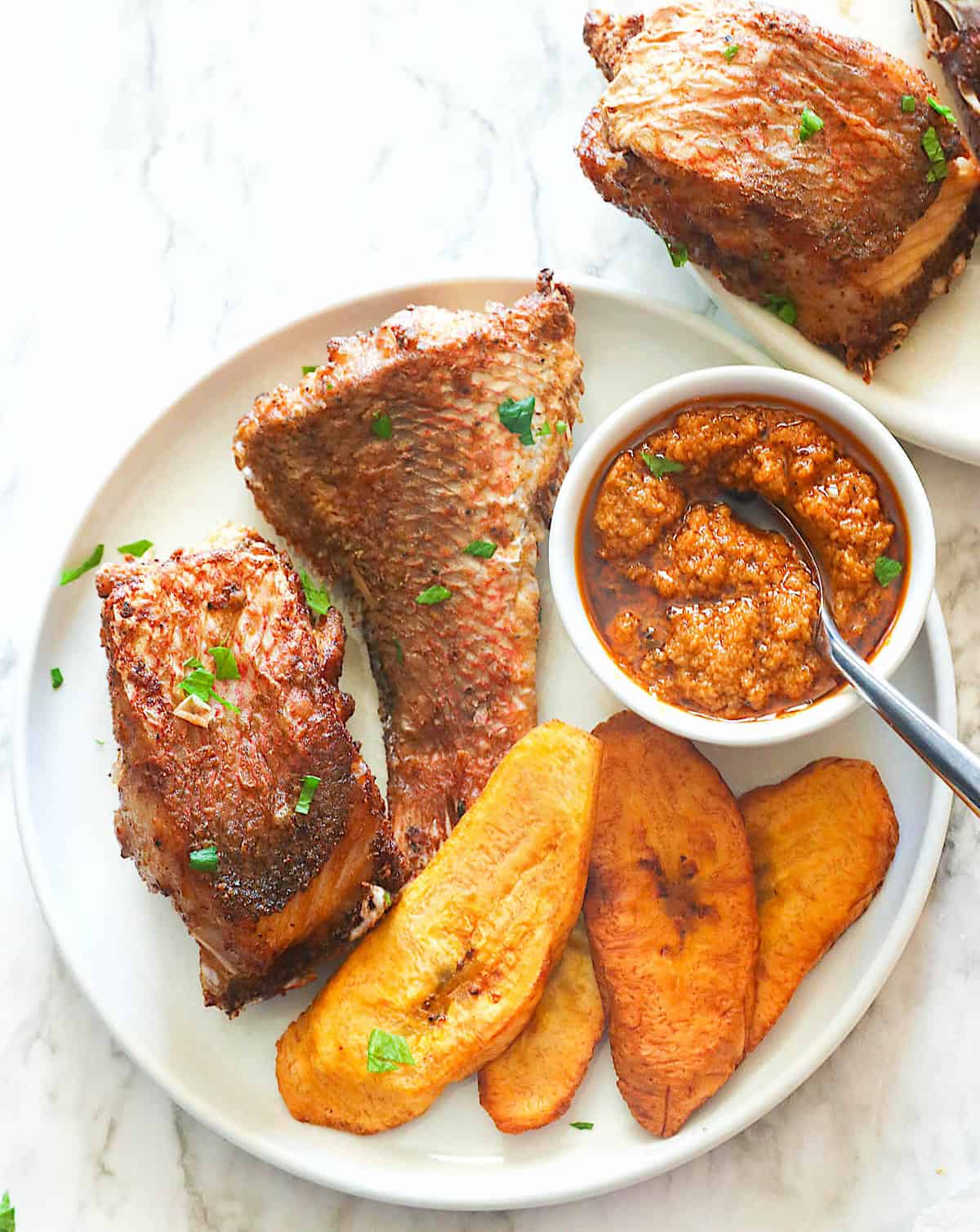 Enjoying fried red snapper and plantains