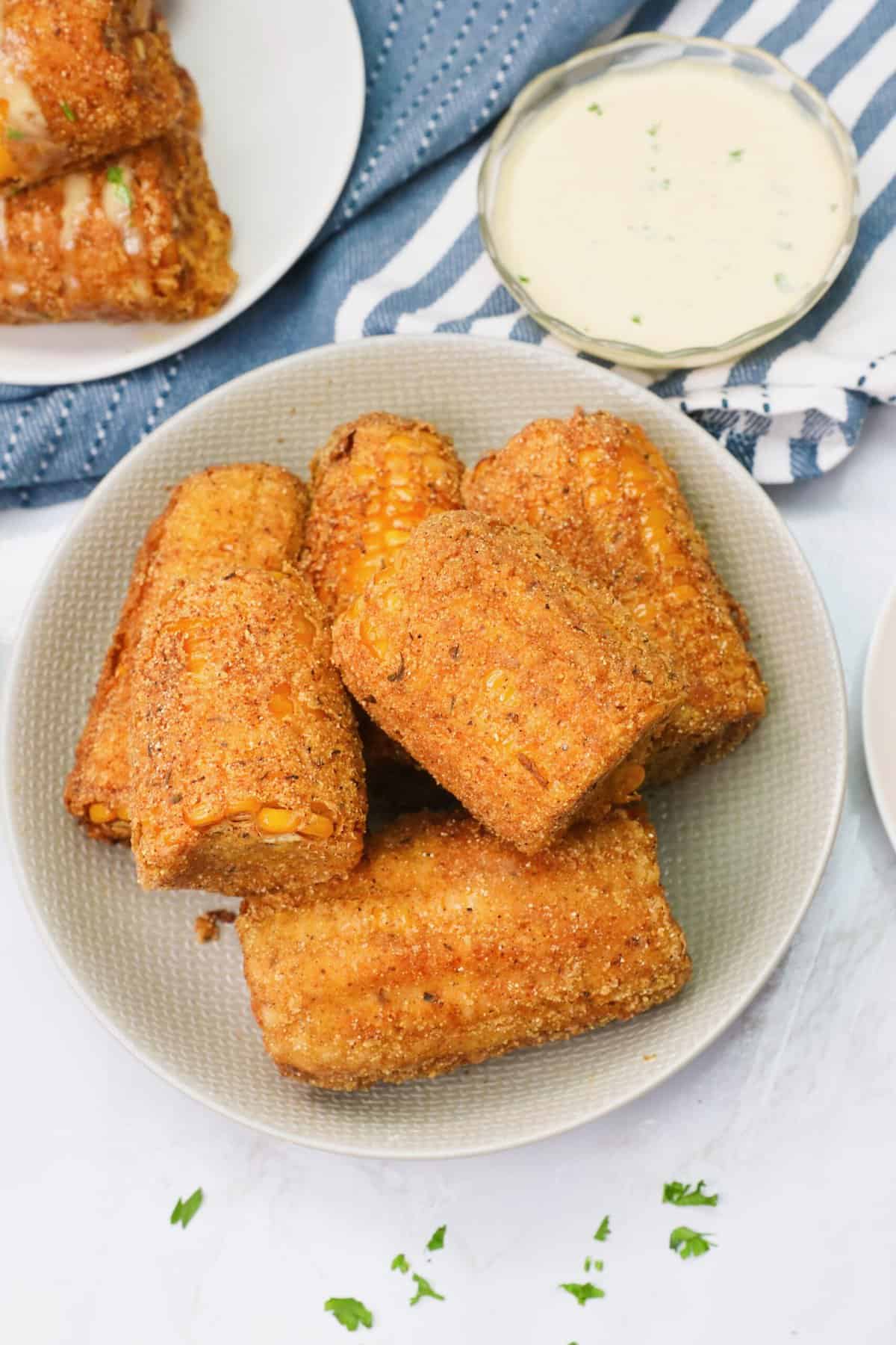 Freshly fried corn on the cob with Cajun seasoning ready to enjoy