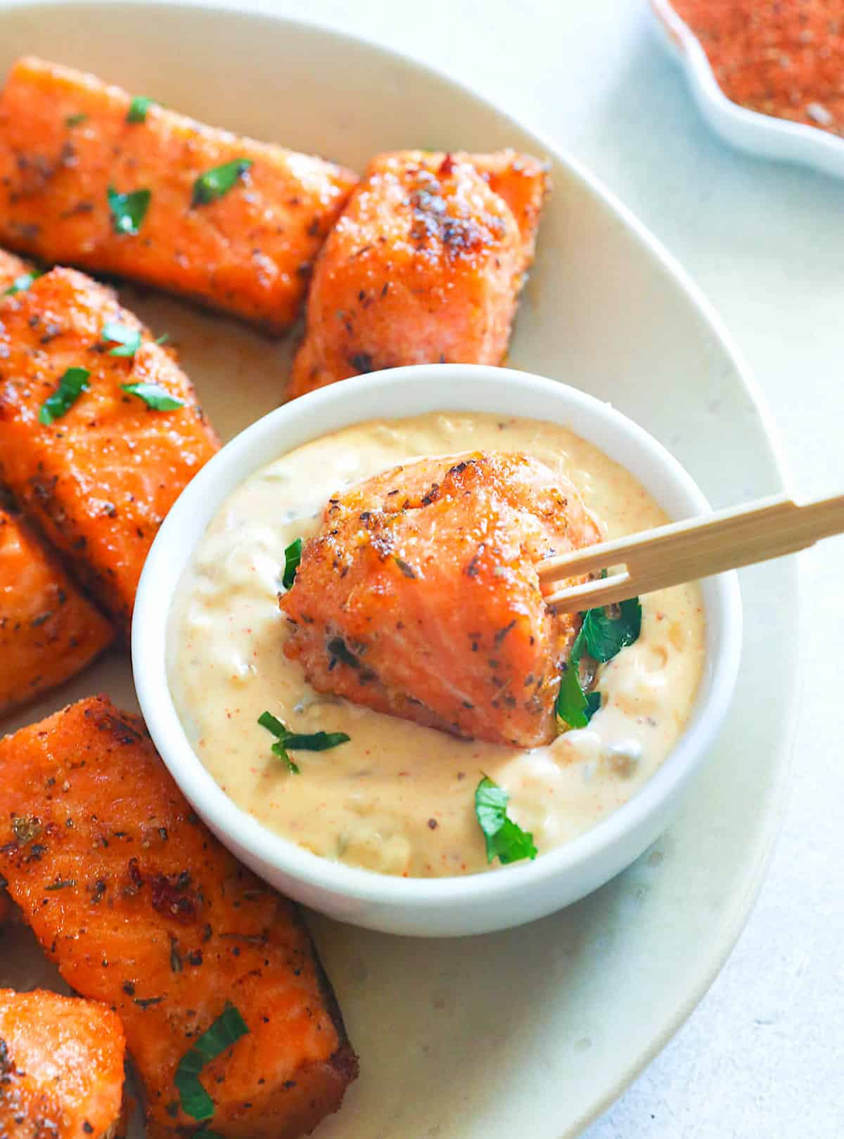 Dipping hot salmon bites in an amazing sauce