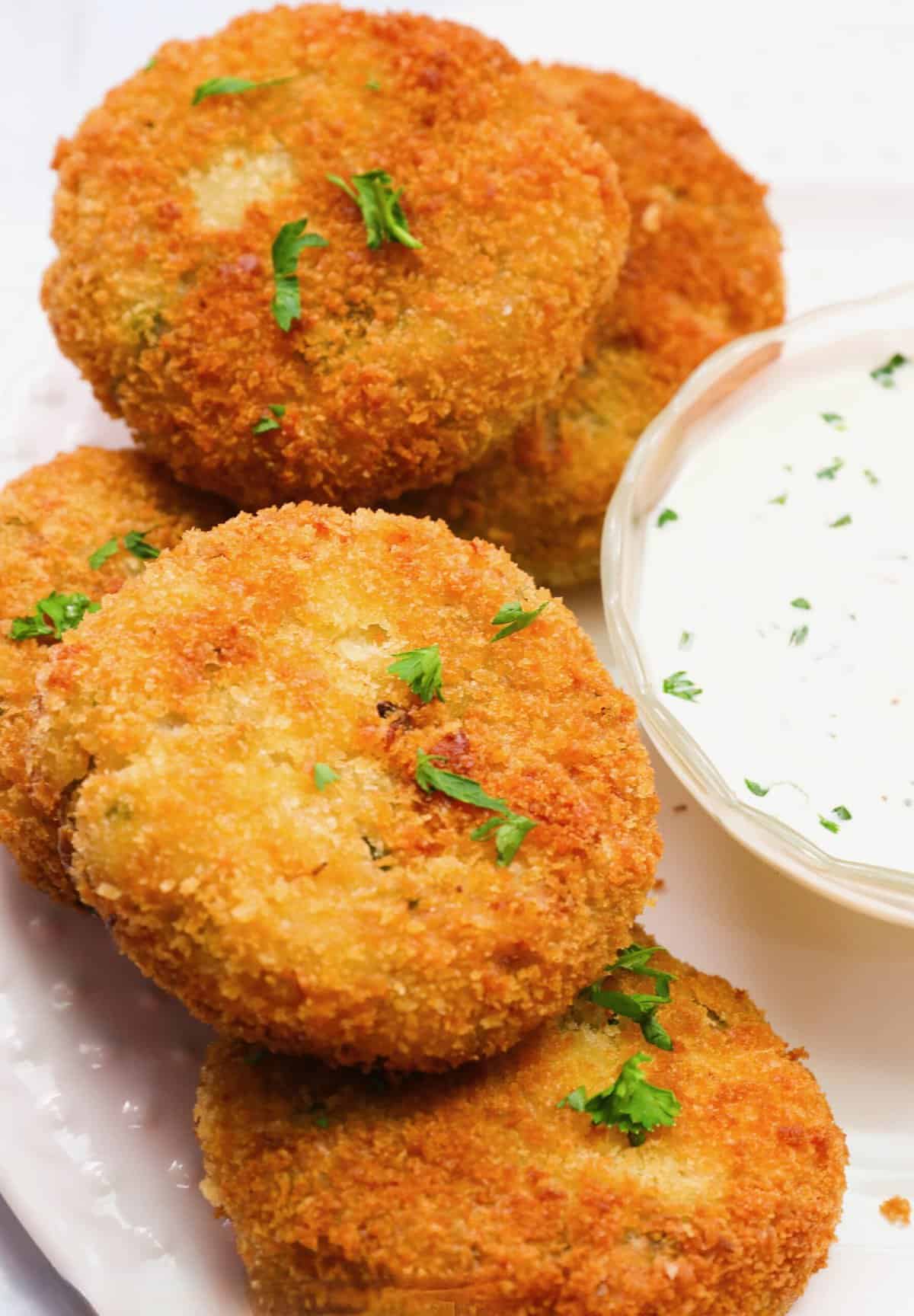 Serving tasty fish cakes with homemade tartar sauce