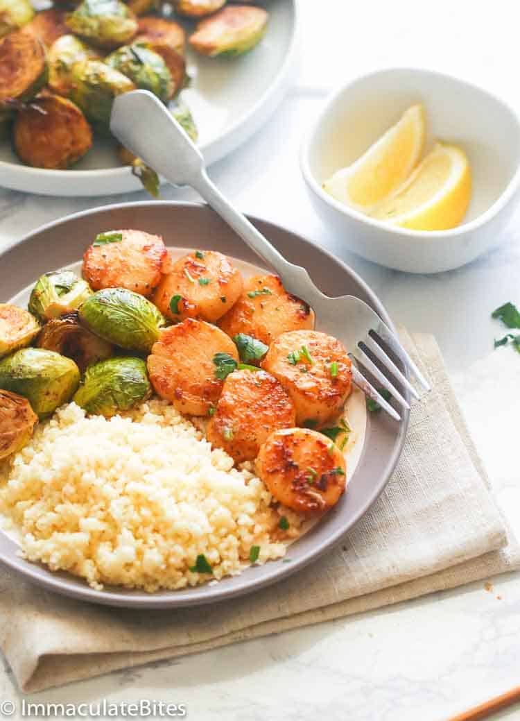 Insanely delicious pan-fried scallops served with rice and sautéed brussels sprouts