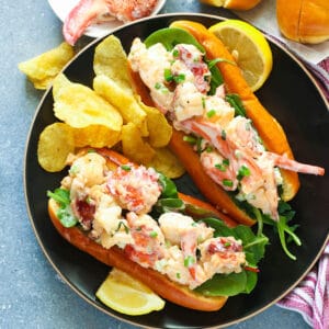 Insanely delicious lobster rolls with potato chips and lemon slices