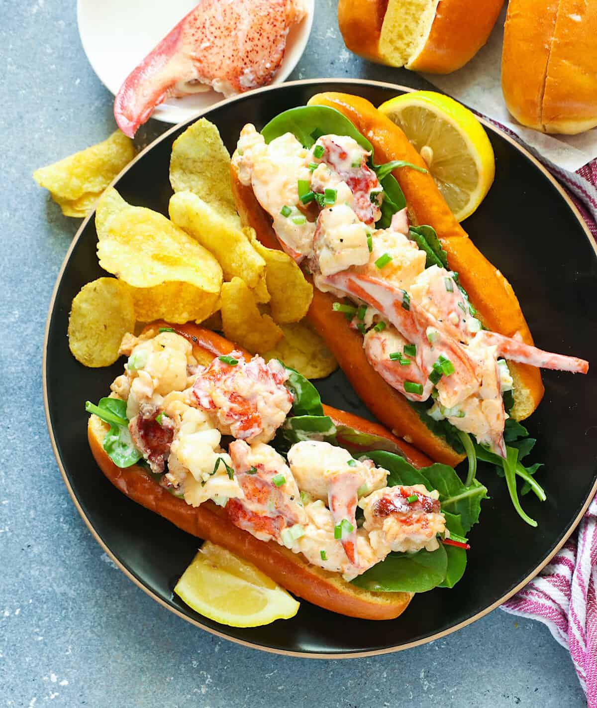 Insanely delicious lobster rolls with potato chips and lemon slices